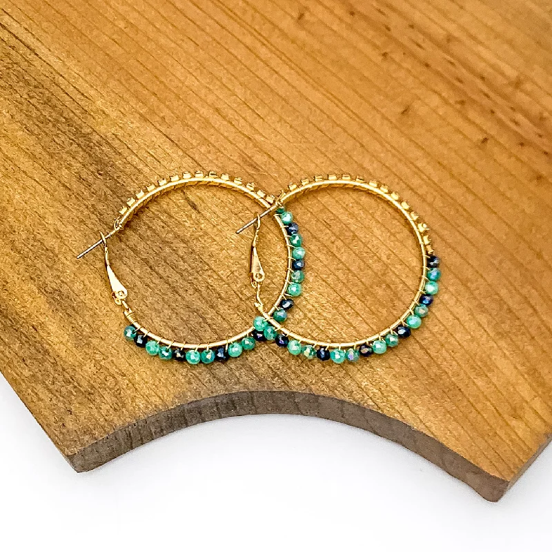 Hoop earrings with oversized designs for a bold, fashion-forward statement-Gold Tone Hoop Earrings Wrapped in Clear and Blue Crystals