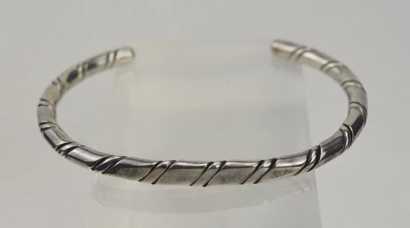 Best bangle bracelets with silver-plated finishes for an affordable and stylish accessory-Twisted Sterling Silver Bangle Bracelet